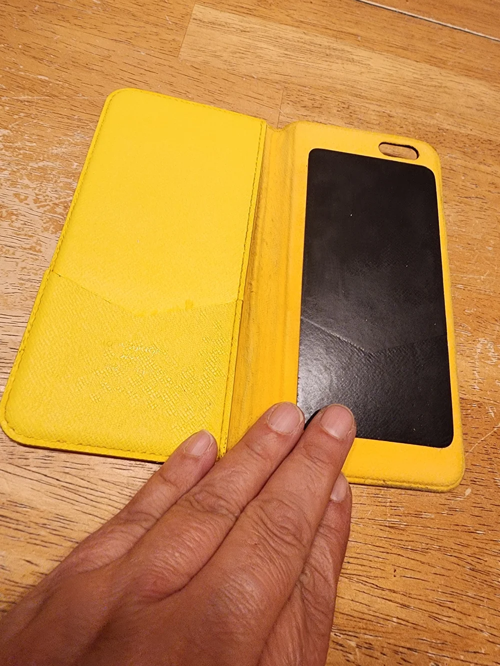 Louis Vuitton Monogram iPhone Folio Case crafted in the brand's signature brown